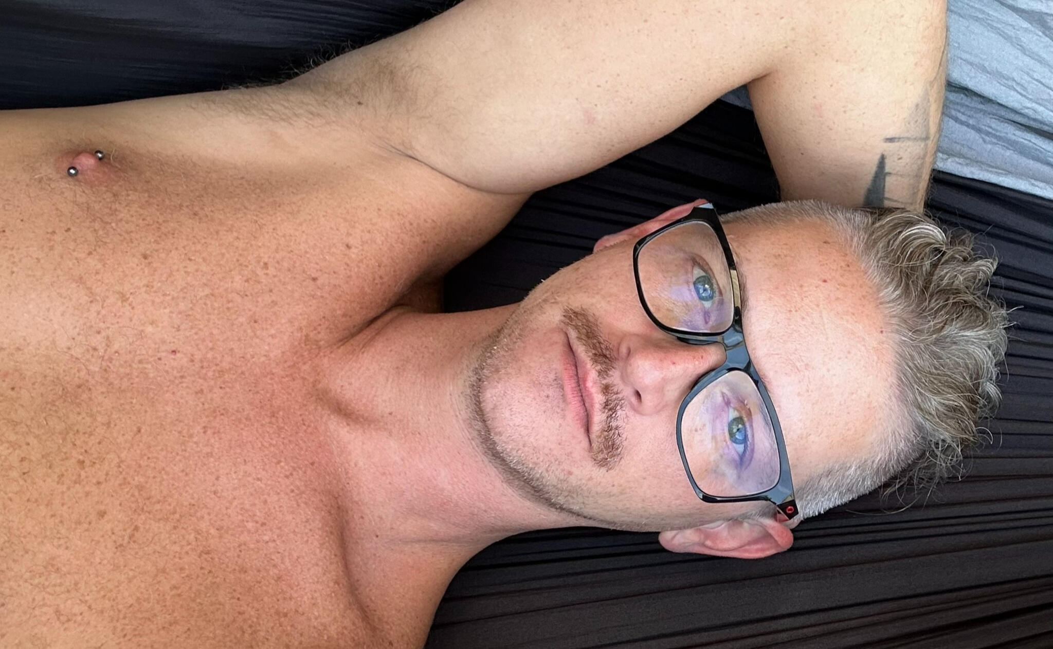 Portrait of Blaize Carpenter in dark, moody tones with gold and red accents.